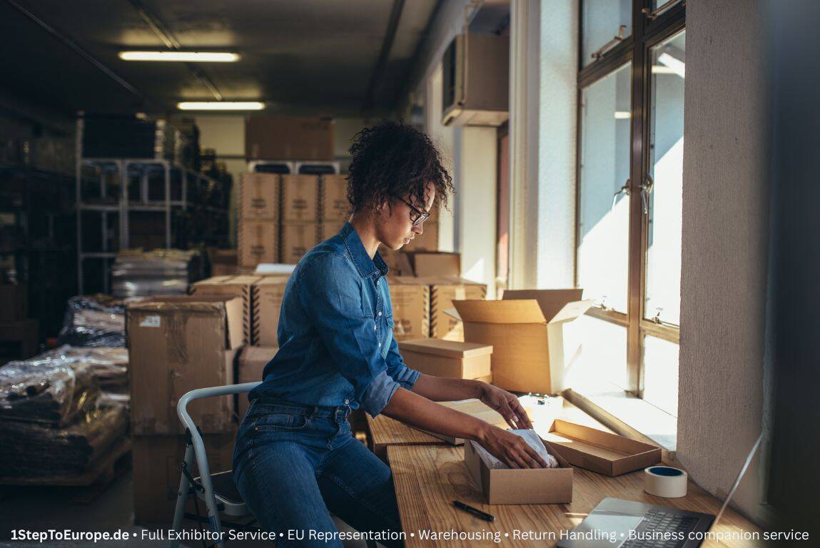 Employee checking returned items at packing station with checklist