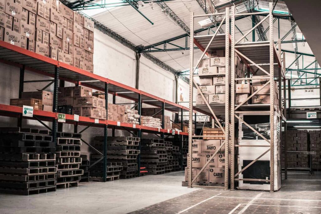 Organized warehouse shelves with labeled shipping boxes, symbolizing professional sample storage in Germany.